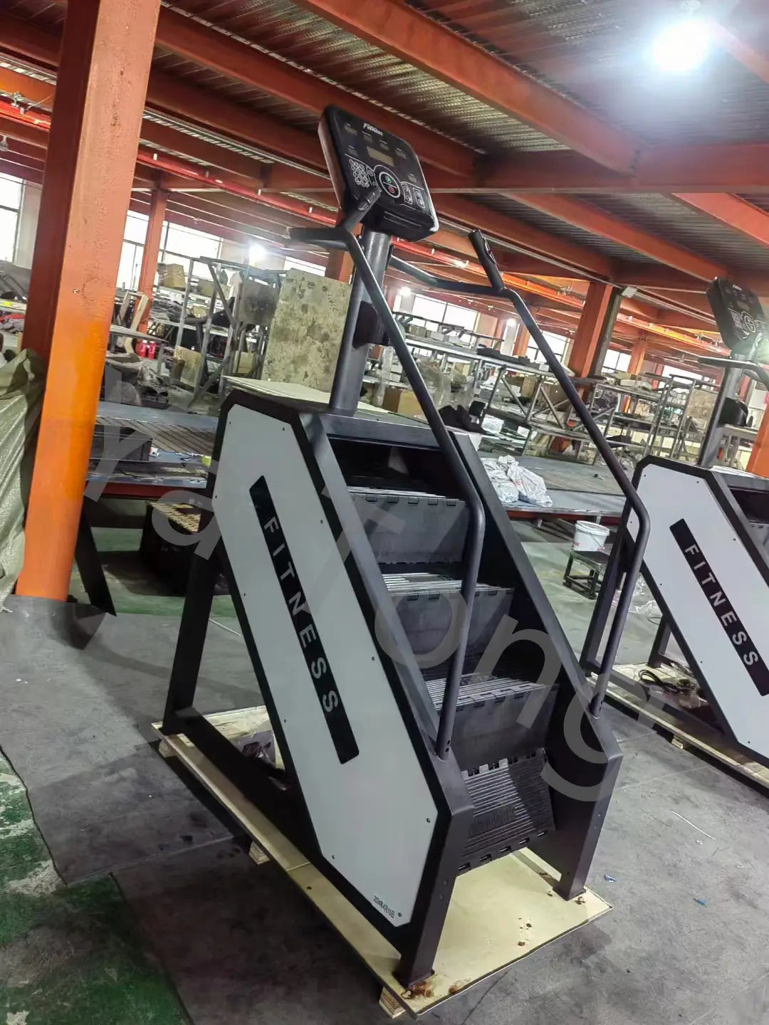 Black and white commercial stair climber machine cardio stepmill with a digital display panel for fitness training.