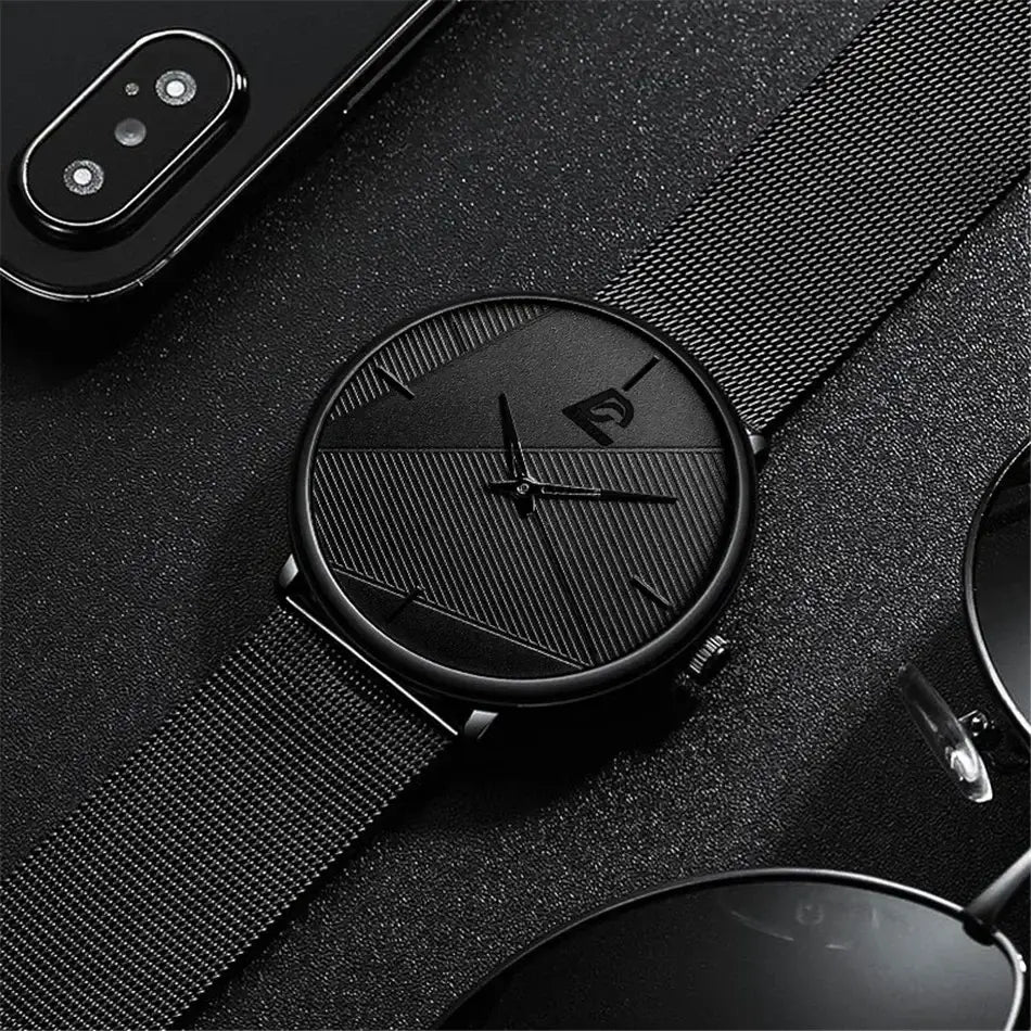 Herrenarmbanduhr aus schwarzem Mesh, Quarz, mit einem minimalistischen Design: ein geometrisch gemustertes Zifferblatt und ein schwarzes Mesh-Armband.
