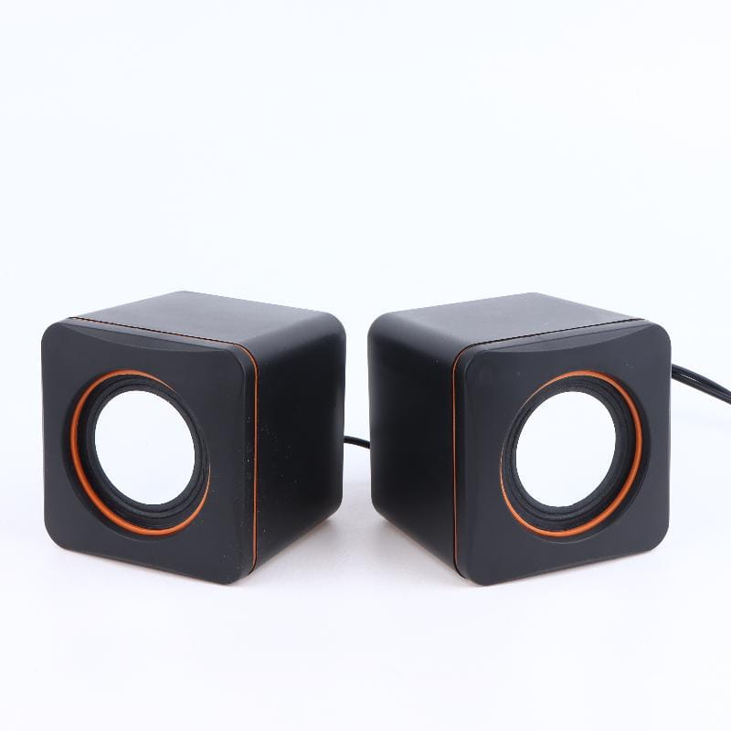 Black cube-shaped usb computer speakers with orange-accented circular drivers and led stereo lights for desktop pc audio use.