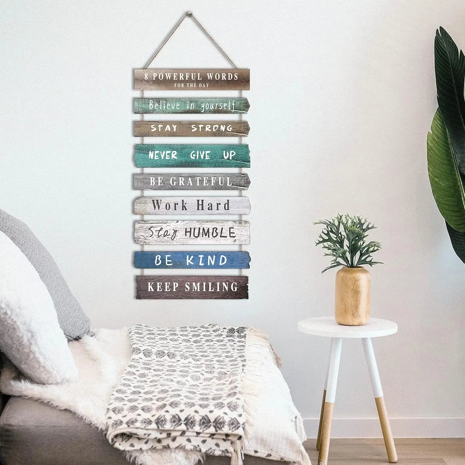 A rustic wooden wall art decor featuring a distressed finish and varied colored motivational phrases for inspirational home decoration.