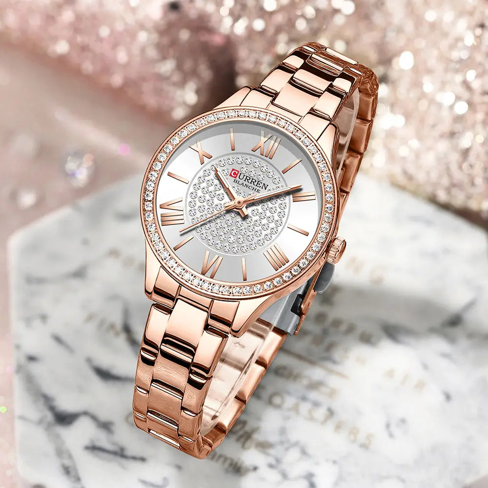 Rose gold Curren women stainless steel crystal quartz watch with diamond-studded bezel and roman numeral dial.