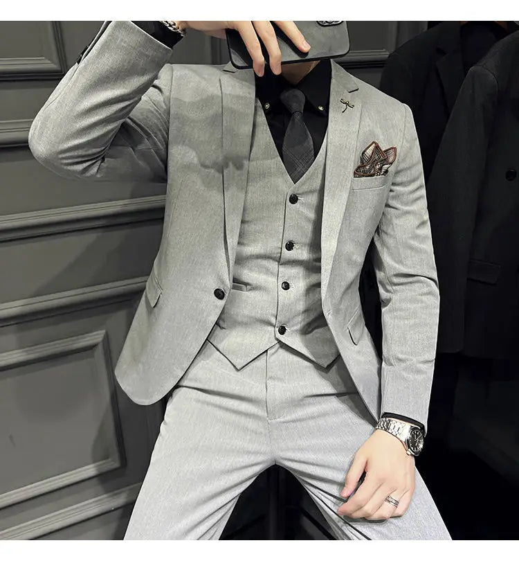 Ensemble de costume slim fit gris clair, élégant et épuré, avec un tissage texturé subtil, gilet assorti et 9 pantalons courts à la cheville, avec fermeture par boutons.