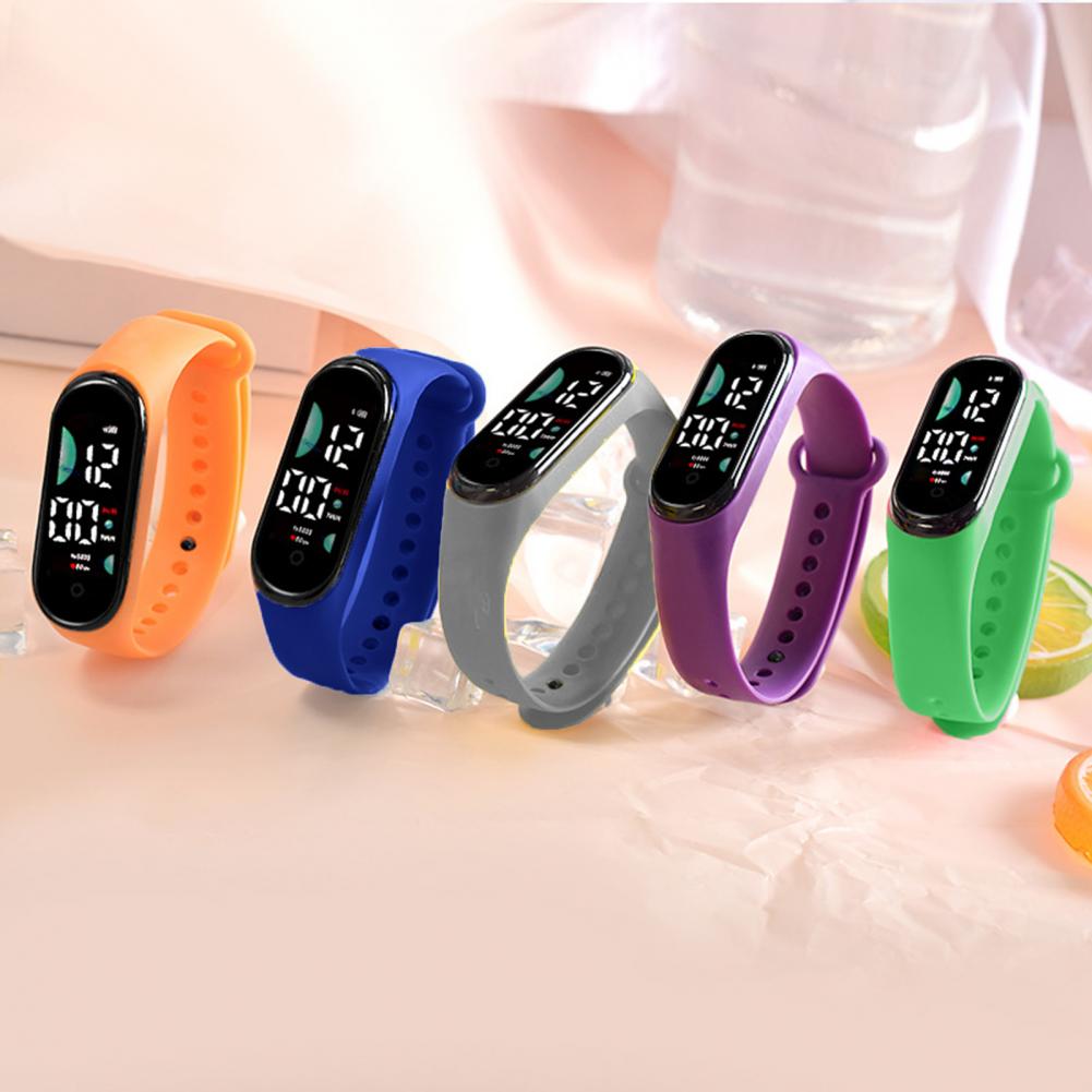 five colorful silicone electronic watches with large font screens in orange, blue, gray, purple, and green designed for sports use.