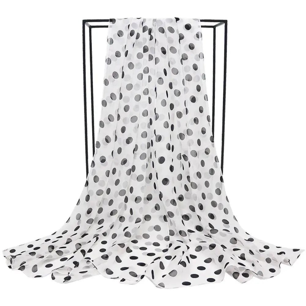 A lightweight sheer white silk head wrap scarf adorned with a pattern of black and gray polka dots.