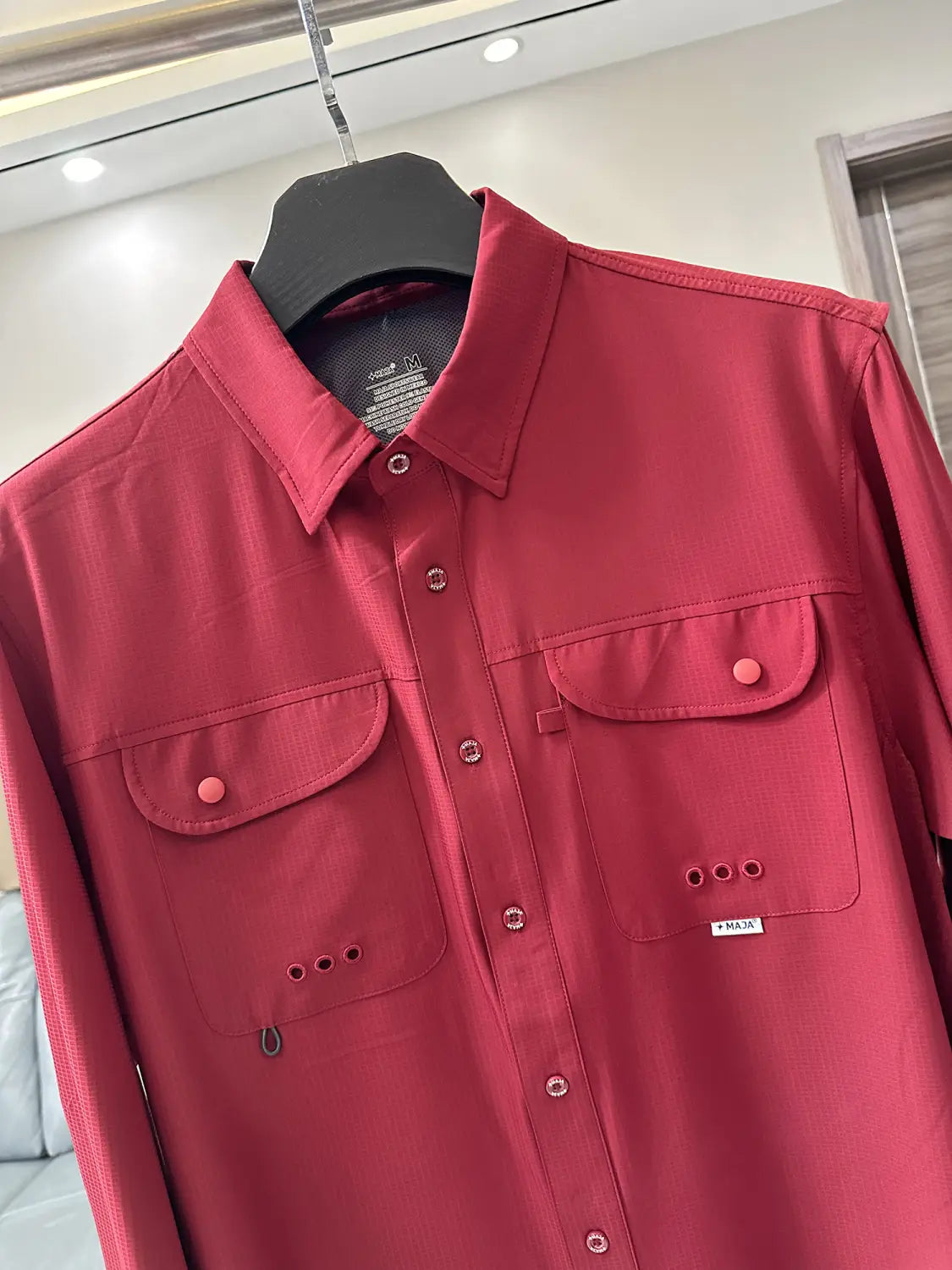 Men’s tactical outdoor long sleeve shirt in vibrant red with button-up front and two chest pockets featuring matching pink buttons.