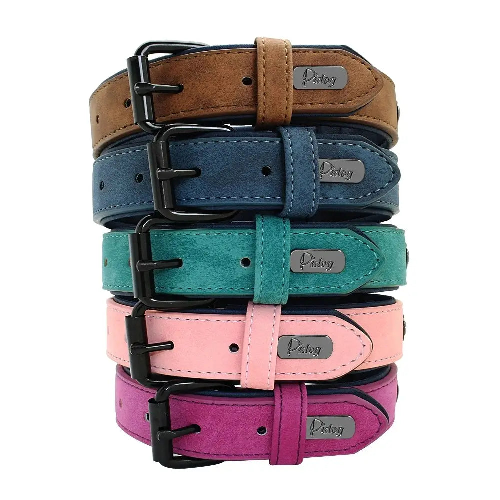 stacked customized leather dog collars in suede-like material featuring black buckles and silver pdog brand nameplates with customization information.