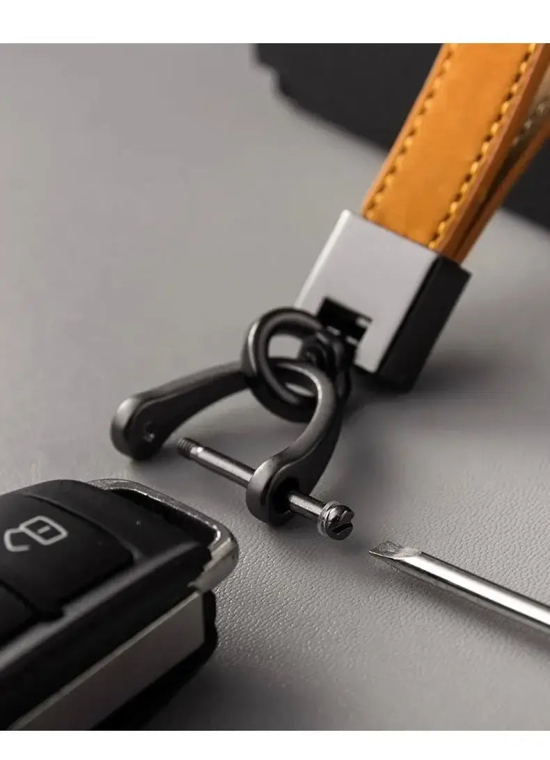 Leather car keychain minimalist key ring in tan leather with a black metal horsebit-style clasp and silver-toned rectangular connector.