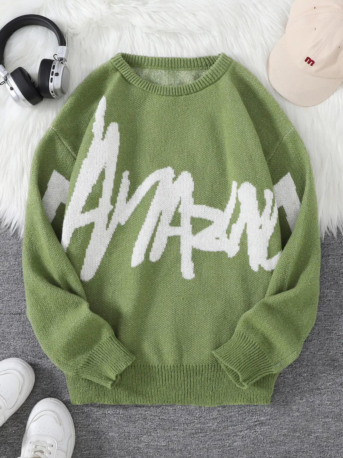 Men black knit sweater featuring a bold white amazing graphic on soft olive green fabric across the chest.