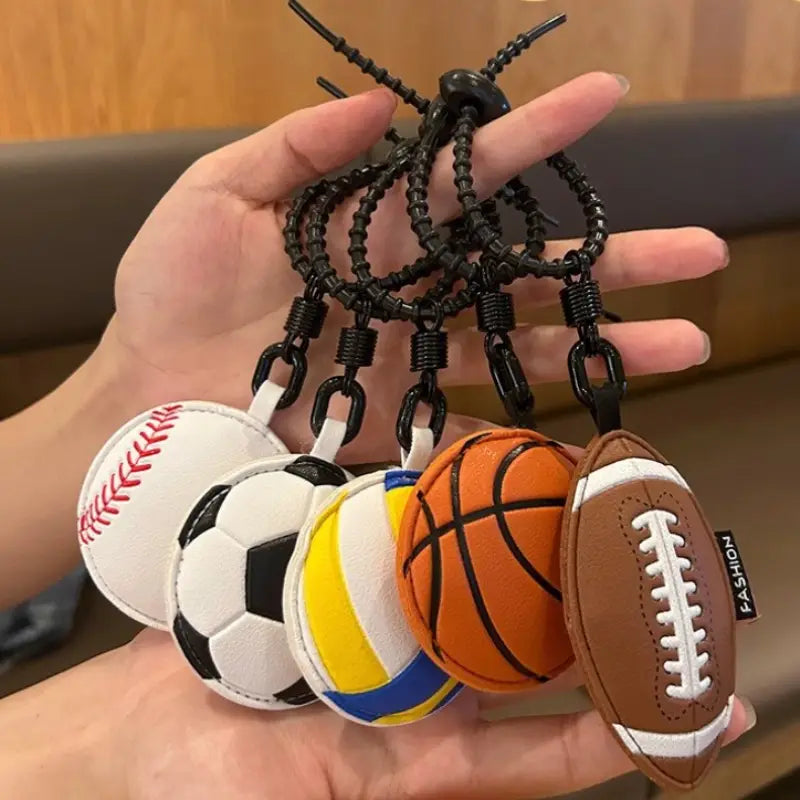 Leather sports ball keychain set featuring five stitched leather keychains in baseball, soccer ball, volleyball, basketball, and football designs for bag charm use.