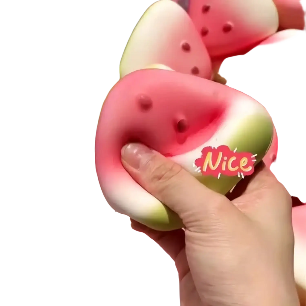 A pink and green watermelon-shaped slow rising squishy toy with black seed details shown from the front angle