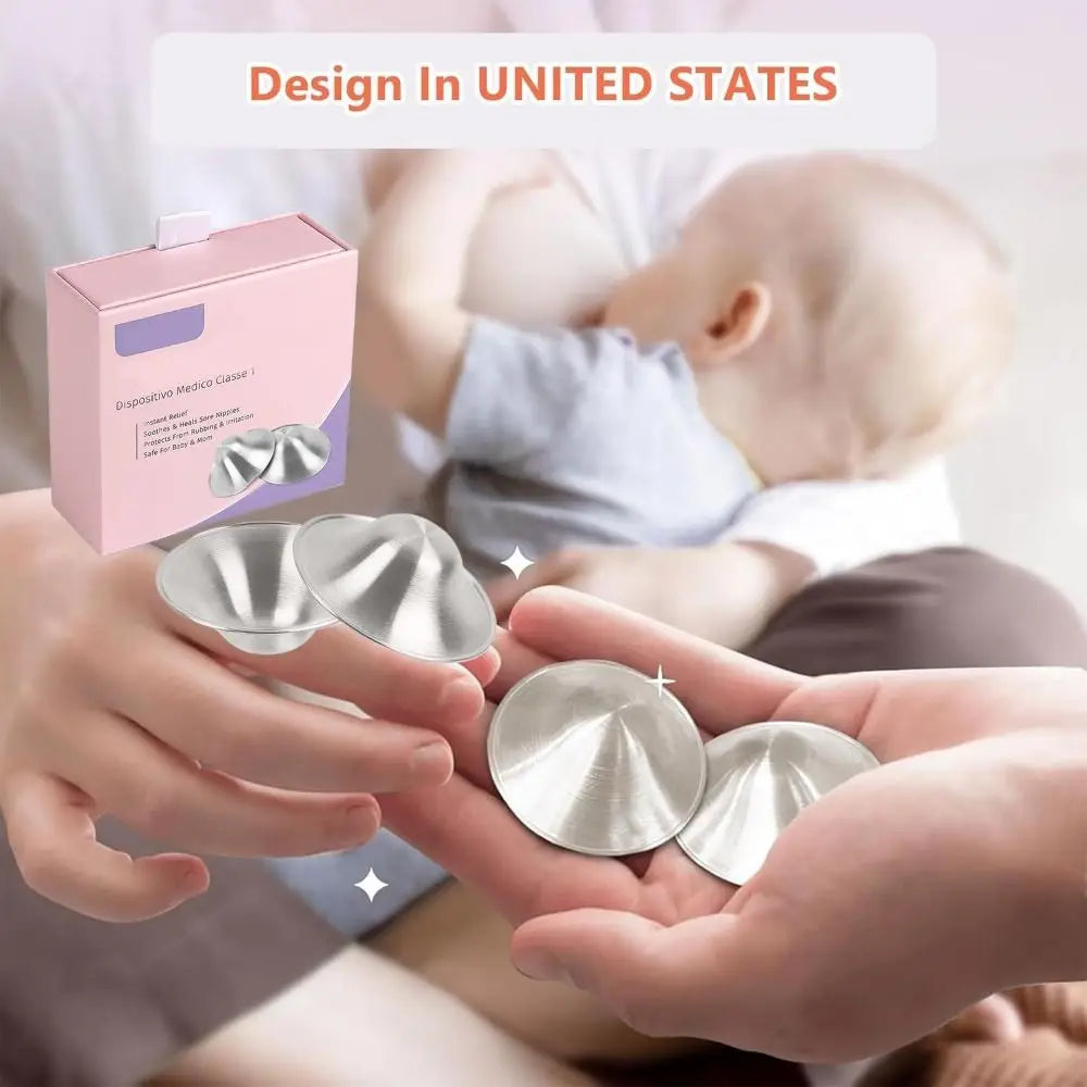Silver dome-shaped nipple shields with a smooth metallic finish designed for breastfeeding to sooth soreness.