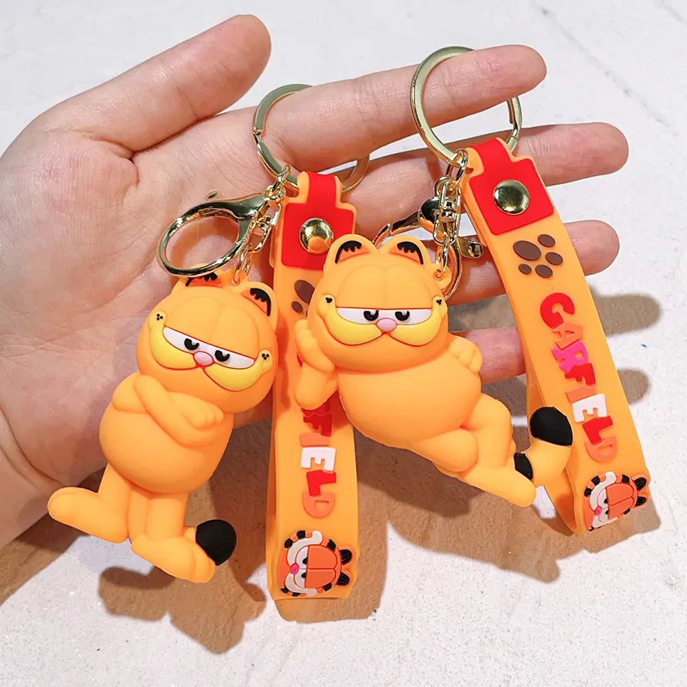 Orange Garfield rubber keychains featuring black paws, pink noses, and a red strap with orange Garfield lettering for anime cat key pendant use.