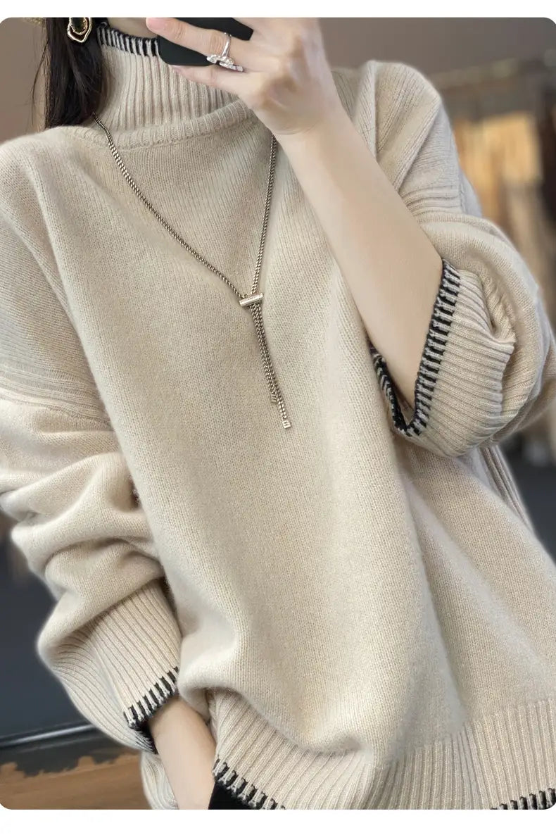 Beige pure wool turtleneck sweater for women with ribbed cuffs and hem accented by black and white striped trim.