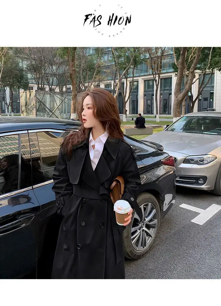 Black double-breasted trench coat for women with a belted waist ideal for casual windbreaker use