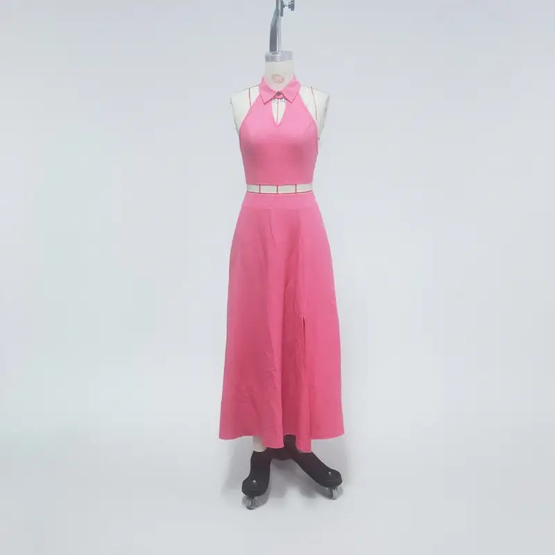 a vibrant pink halter two piece set maxi skirt with a white collar detail and matching belt displayed on an ice skater mannequin featuring a halter neck closure type.