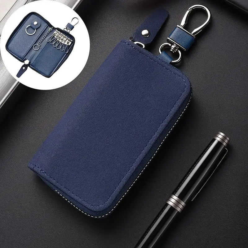 Navy blue leather key holder organizer pouch with silver-toned zipper and metal carabiner clip for secure key storage.