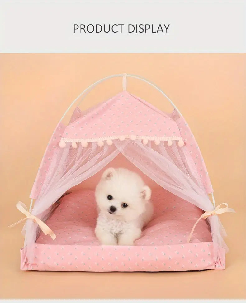 Pink polka-dotted pet tent with sheer mesh sides and pom-pom trim designed as a floral print cave bed for cats and dogs.