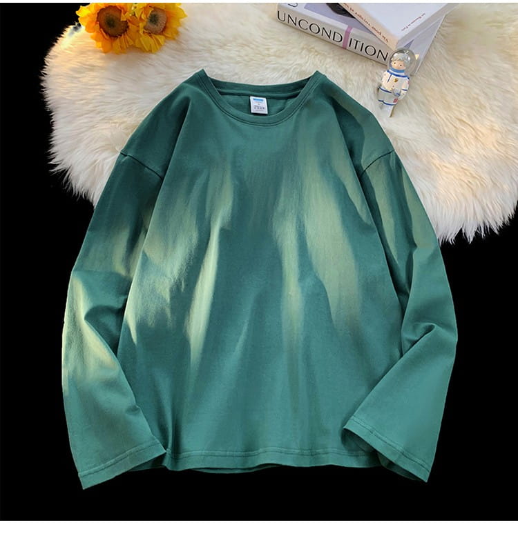 A soft oversized long sleeve blank t-shirt in a green gradient featuring a subtle fade from darker to lighter tones.