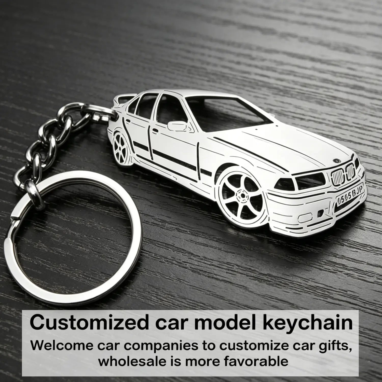 Silver metallic keychain featuring a detailed die-cut model of a BMW E36 sedan with black line detailing and chrome accents for personalized vehicle key pendant use.