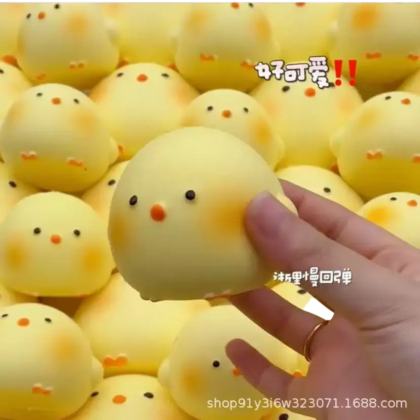 A soft pale yellow giant chicken squishy toy with black eyes and orange beak for stress relief and sensory use