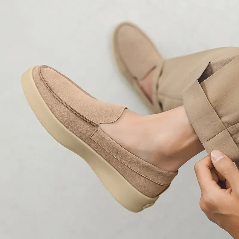 Beige suede slip-on men casual loafers with a thick off-white rubber sole designed for walking.