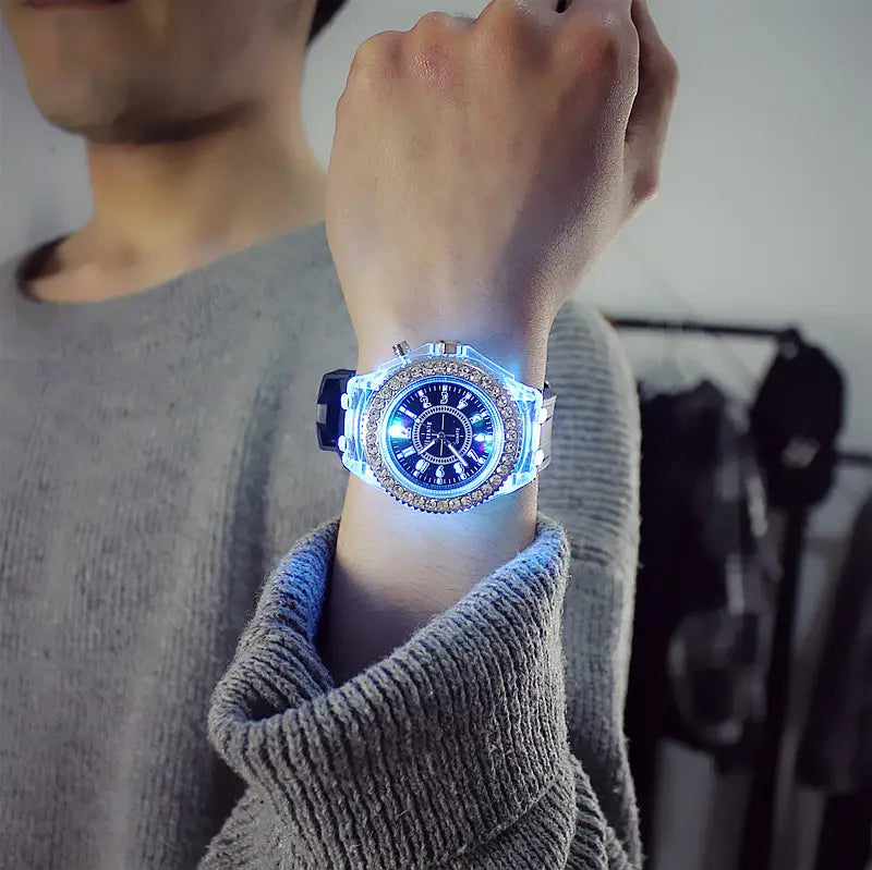 A glowing blue led luminous silicone watch rhinestone digital timepiece with a transparent case and crystal embellishments.