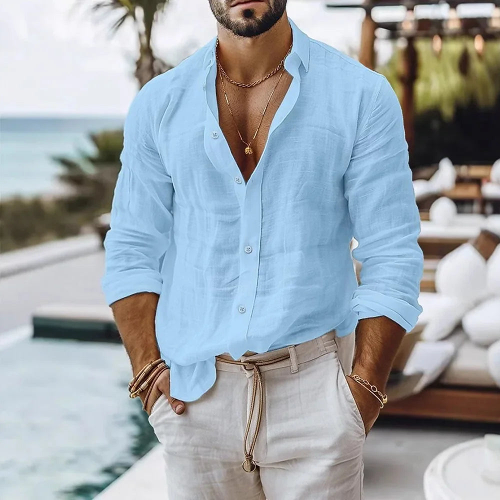 Men’s light blue long-sleeved linen beach shirt made of lightweight fabric with rolled-up sleeves.