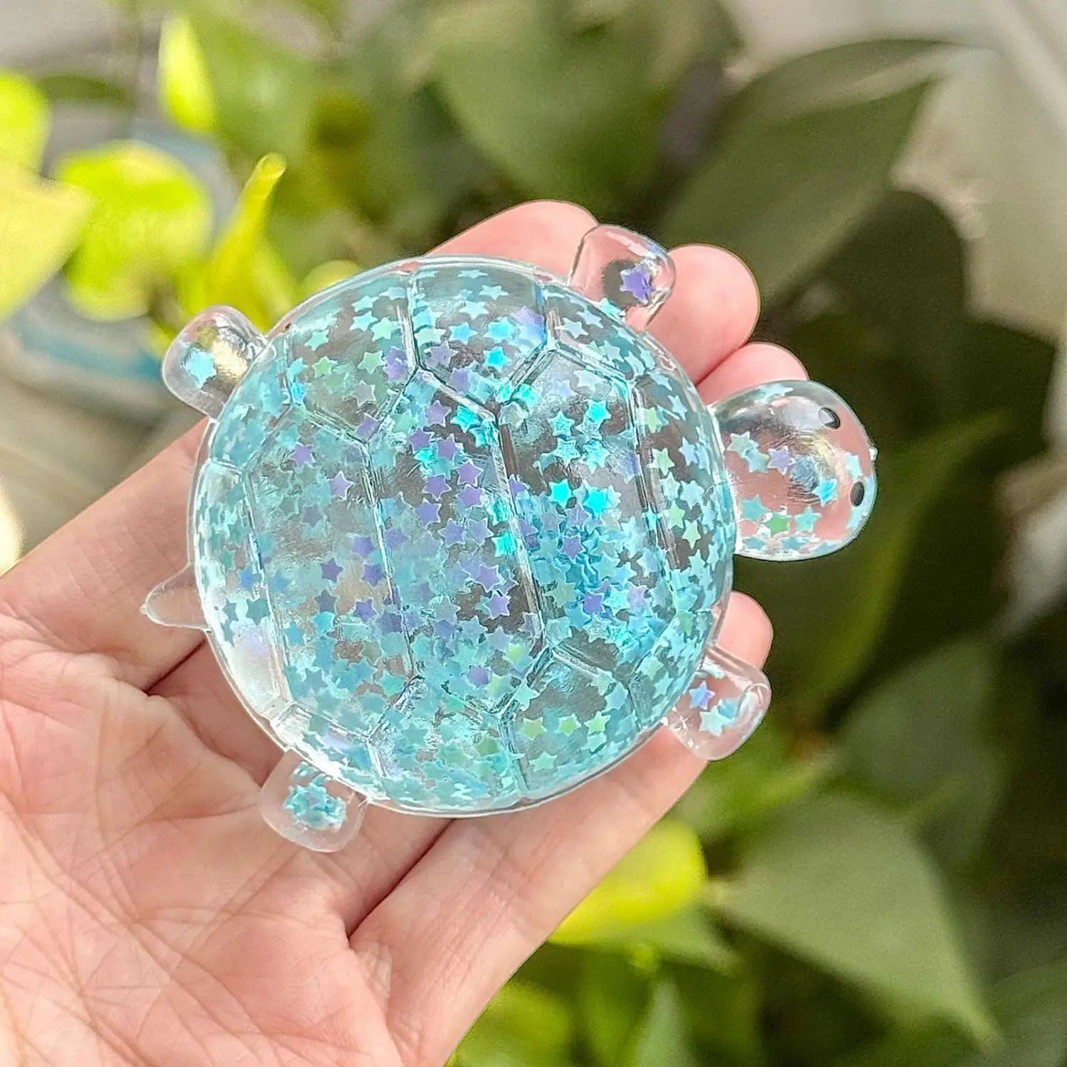 translucent blue starry gel glitter turtle squeeze toy sensory fidget with clear plastic limbs and a glossy iridescent finish designed as a turtle shape stress reliever squeeze toy