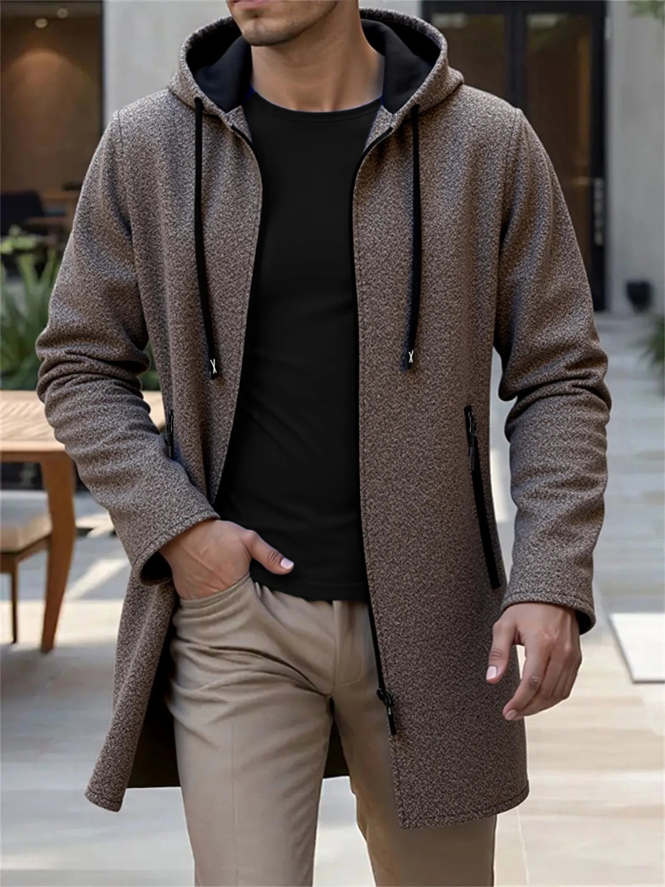A textured brown men’s fleece lined knit hooded jacket with black drawstrings and zipper accents.