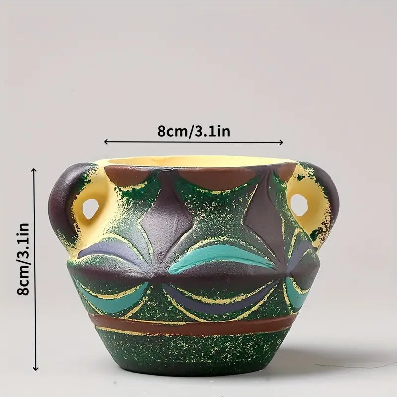 A small hand-painted ceramic succulent planter pot with a textured green base and decorative patterns in brown teal and gold without packaging damage.