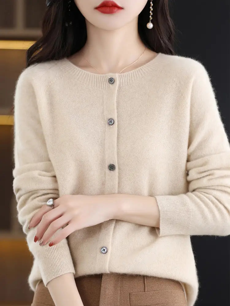 Cream-colored merino wool cardigan for women featuring long sleeves, a round neckline, and dark gray buttons, suitable as a cashmere knit sweater.