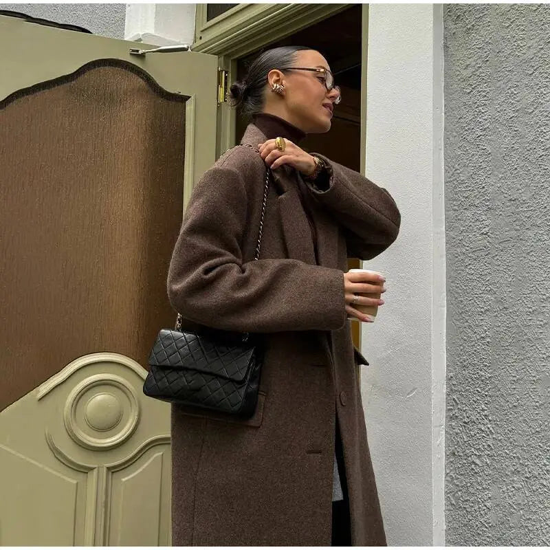 black quilted leather handbag with chain strap paired with brown wool blend overcoat for women winter commuter jacket.