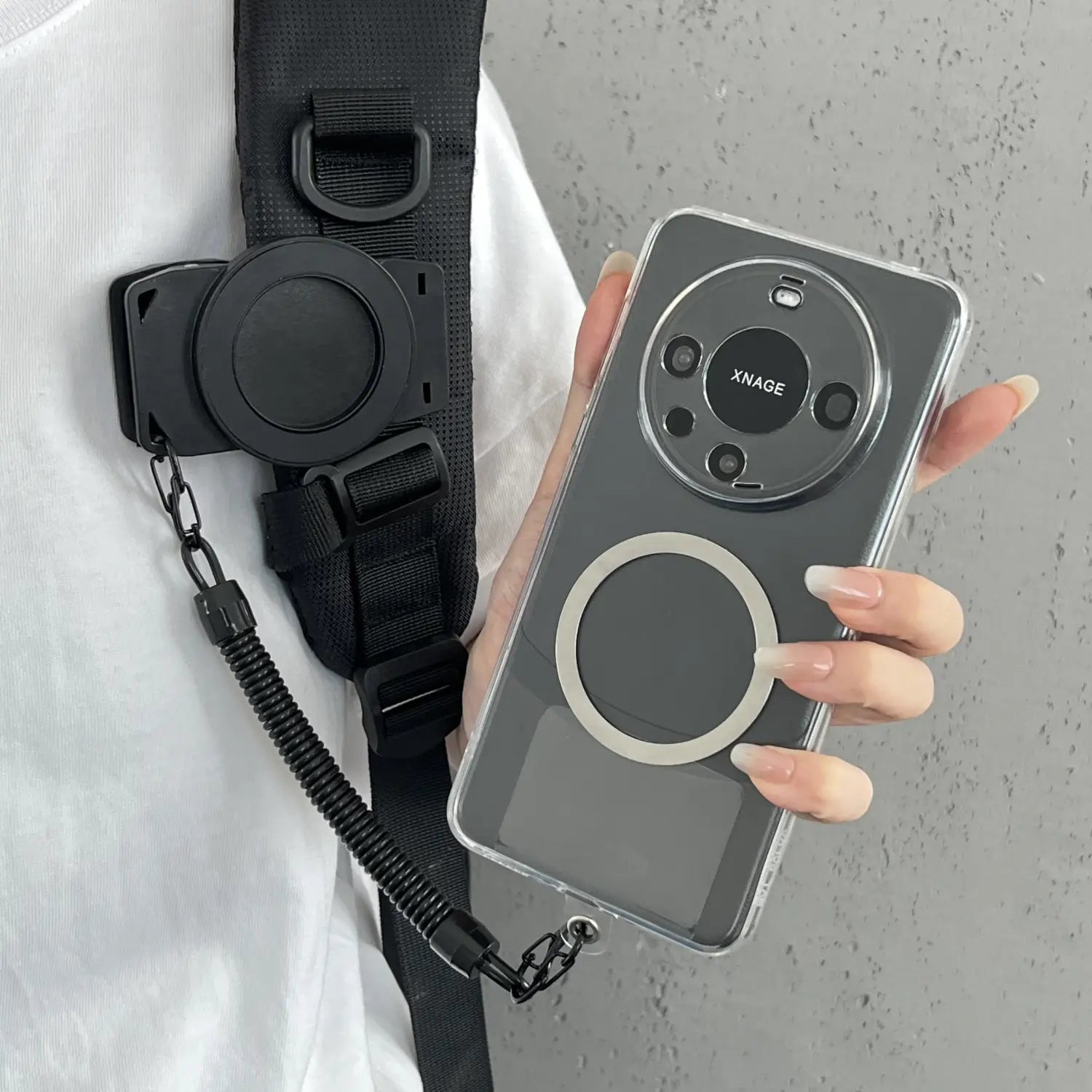 Eine elegante transparente Telefonhülle mit einem kreisförmigen Magnetring und schwarzem Kameralaschen-Gehäuse für ein Xnage-Smartphone, dargestellt von der Rückseite als Teil eines Produkts der magnetischen Telefon-Rucksackclip Universalhalterung
