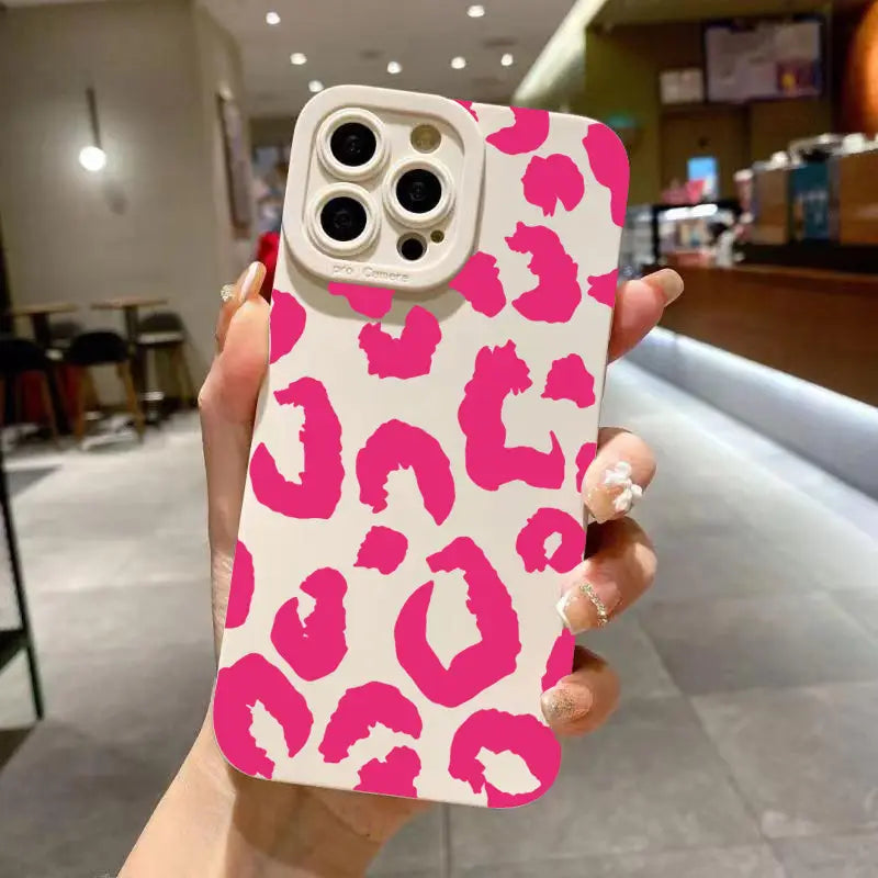 A vibrant pink and white leopard print glossy phone case designed for the back of an iPhone Pro model with matte black camera protection.