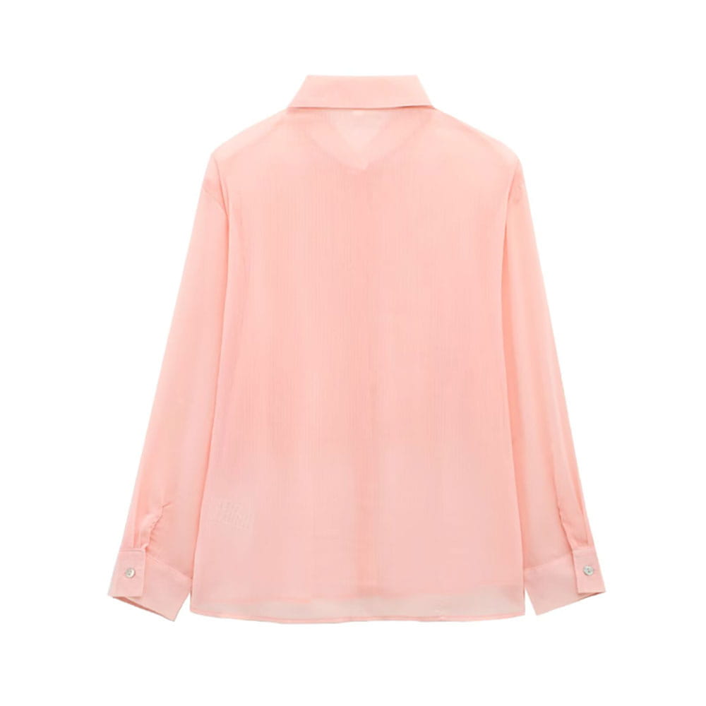 A delicate pink textured ruffled silk blouse with a classic collar and buttoned cuffs.