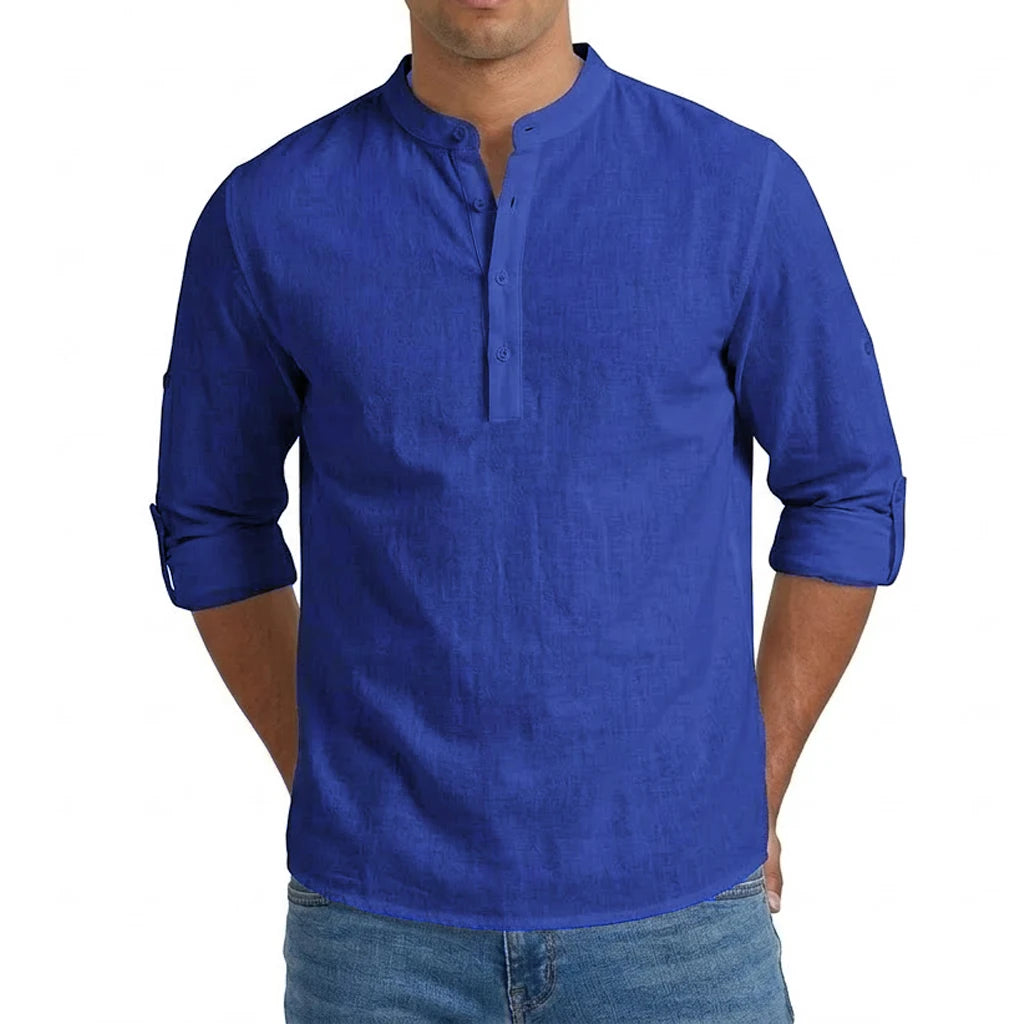 Royal blue men’s linen blend long sleeve Henley shirt featuring rolled-up sleeves and a buttoned mandarin collar.