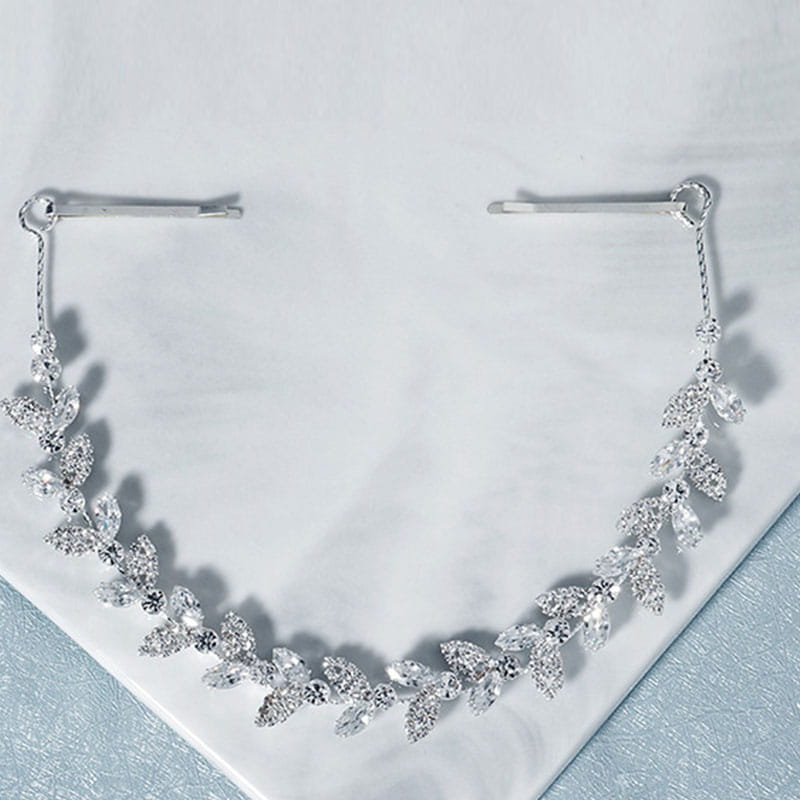 Silver leaf-shaped bridal headband adorned with sparkling crystals and delicate metal bobby pins wedding hair accessory.
