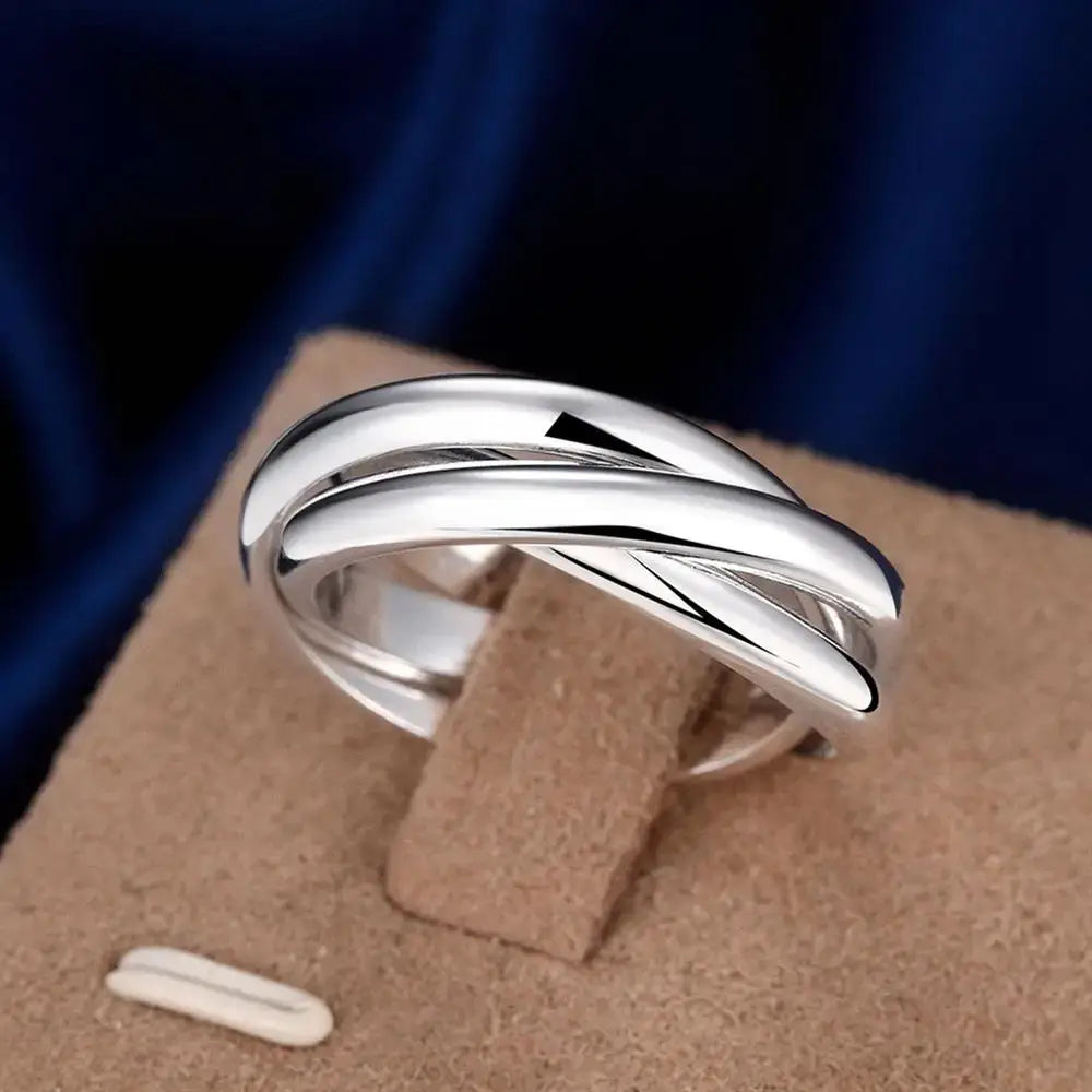 A sleek silver sterling silver ring for women featuring a modern simple three circles design with three interwoven bands.