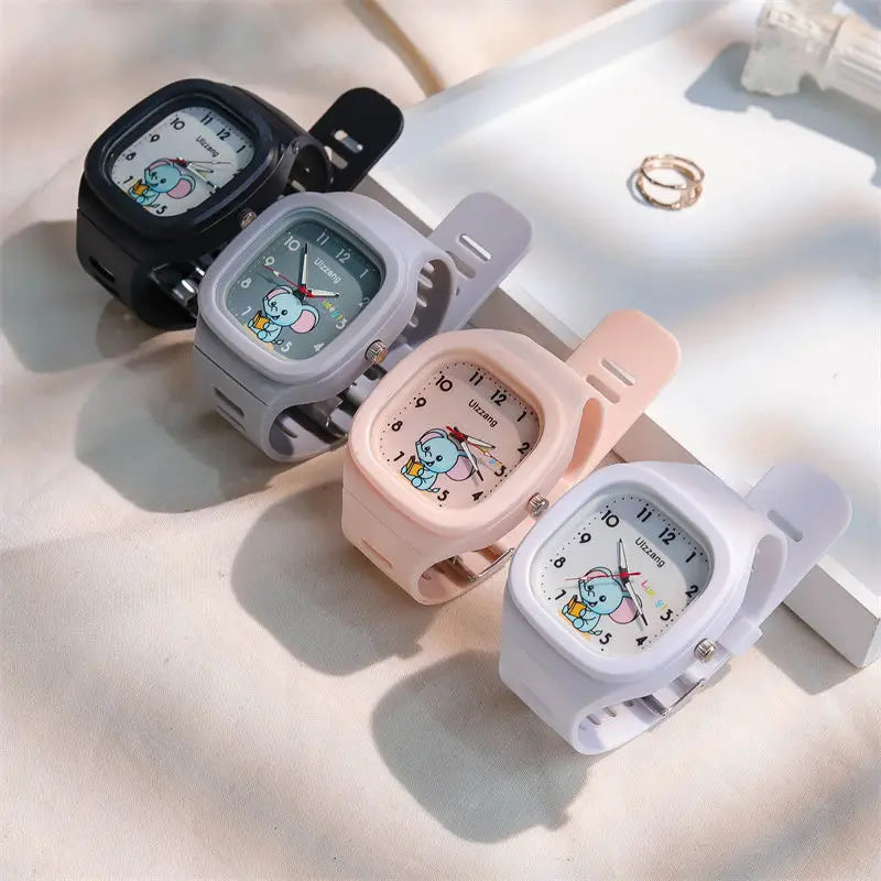 Four colorful silicone kids luminous cartoon elephant digital watches with square faces in black gray pink and white cases.