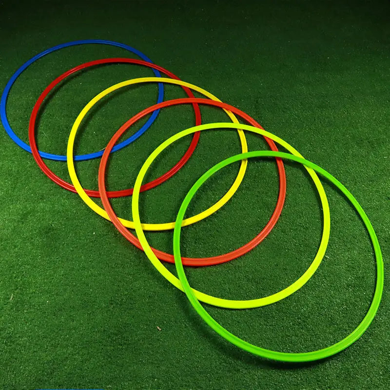 Set of colorful plastic agility training rings in blue red yellow and green for soccer speed exercise equipment.