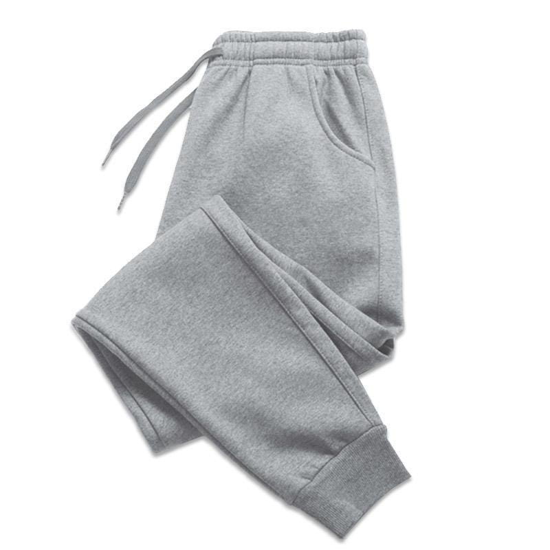 Survêtements pour homme en molleton, type jogger, en tissu gris chiné, avec taille élastique, cordon, poches latérales et poignets côtelés, pour un usage décontracté à l’entraînement.