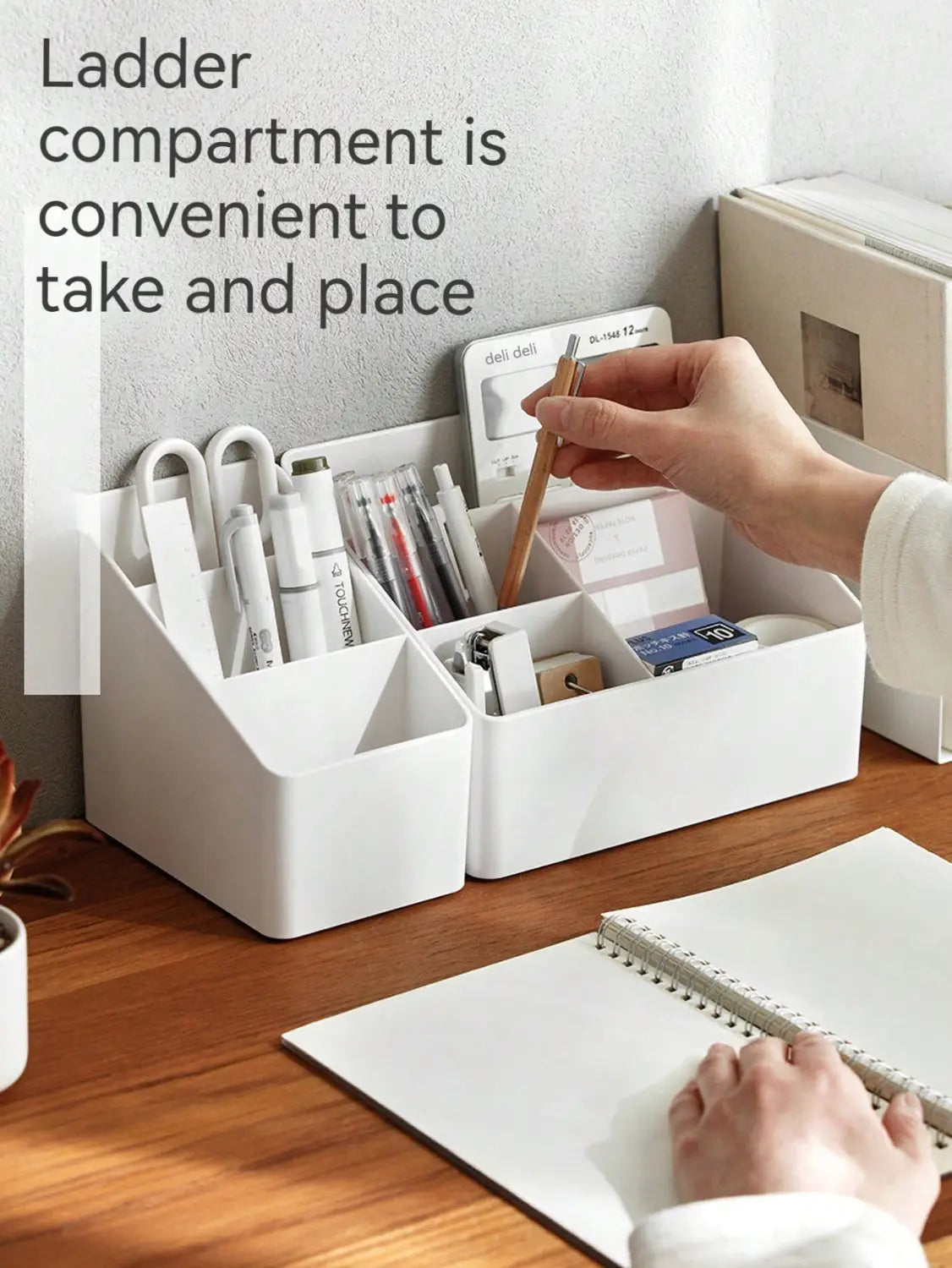 White plastic desk organizer and remote holder with ladder-style multiple compartments holding pens scissors and office supplies.