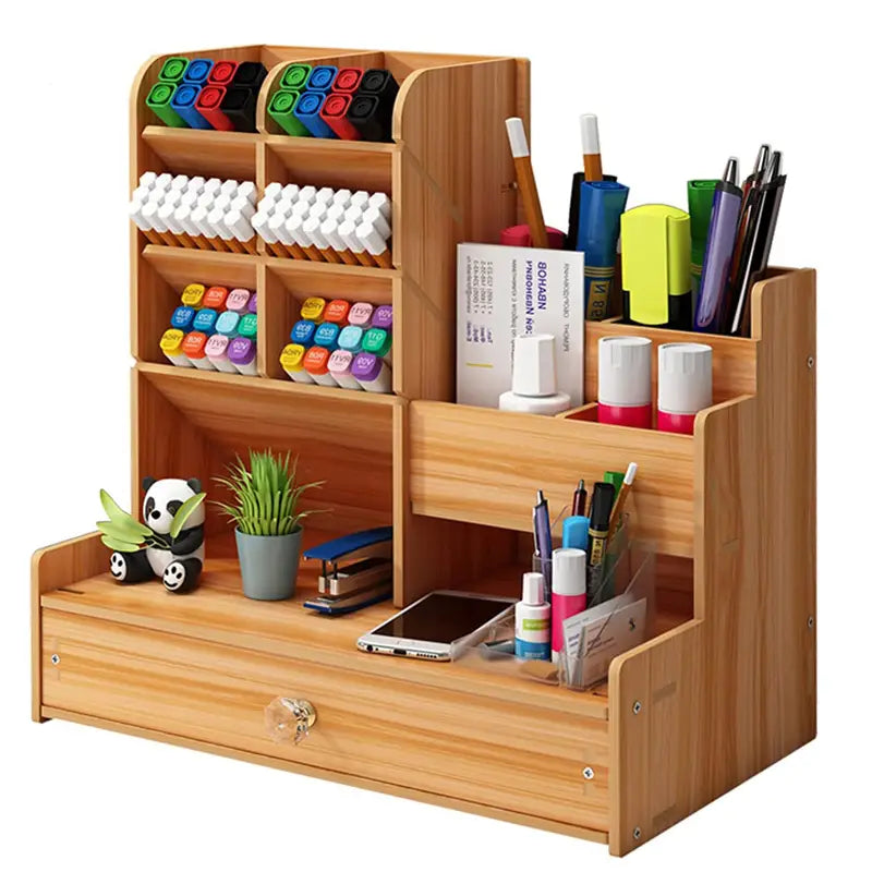 Wooden desk organizer with drawer in light wood grain featuring multiple compartments holding markers pens and office supplies.