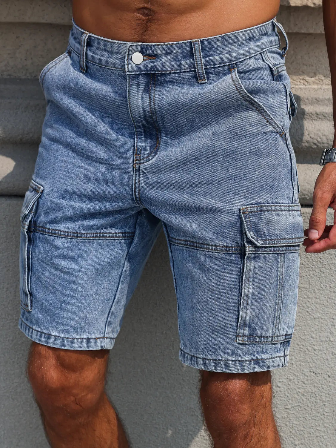 Men blue denim cargo shorts in light-wash with multiple pockets and classic button closure for a regular fit.