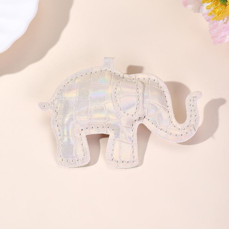 A white iridescent pu leather elephant keychain with quilted texture and stitched edges used as a diy animal charm.