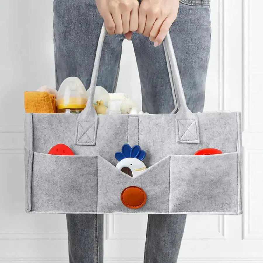 Grauer Filz-Windel-Organizer mit Tragekorb-Form, mit mehreren Taschen, die vorne ein Design mit blau-weißen Küken zeigen.