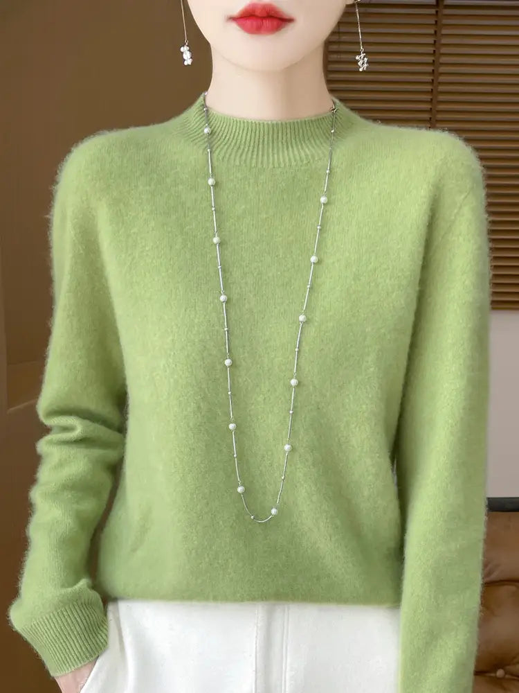A soft light green cashmere sweater with ribbed crew neckline and cuffs in a merino wool pullover sweater for women.