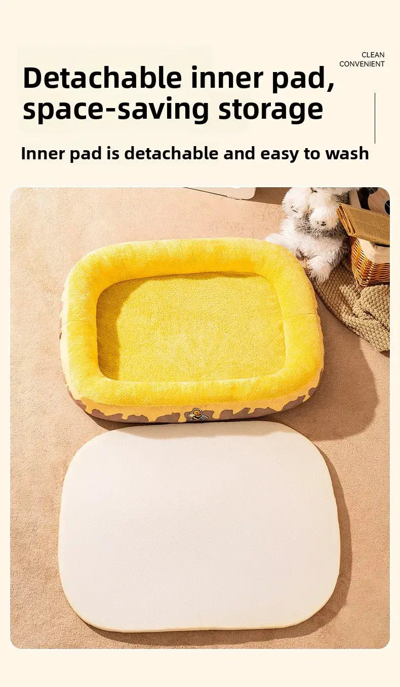 Plush donut dog bed in yellow with a detachable white inner pad and giraffe-patterned outer border featuring a bee accent.