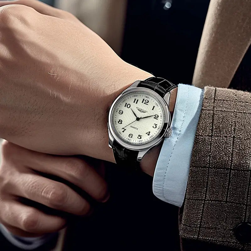 Mens quartz leather watch waterproof business featuring a silver-toned analog dial with cream color, classic arabic numerals, and a black leather strap.