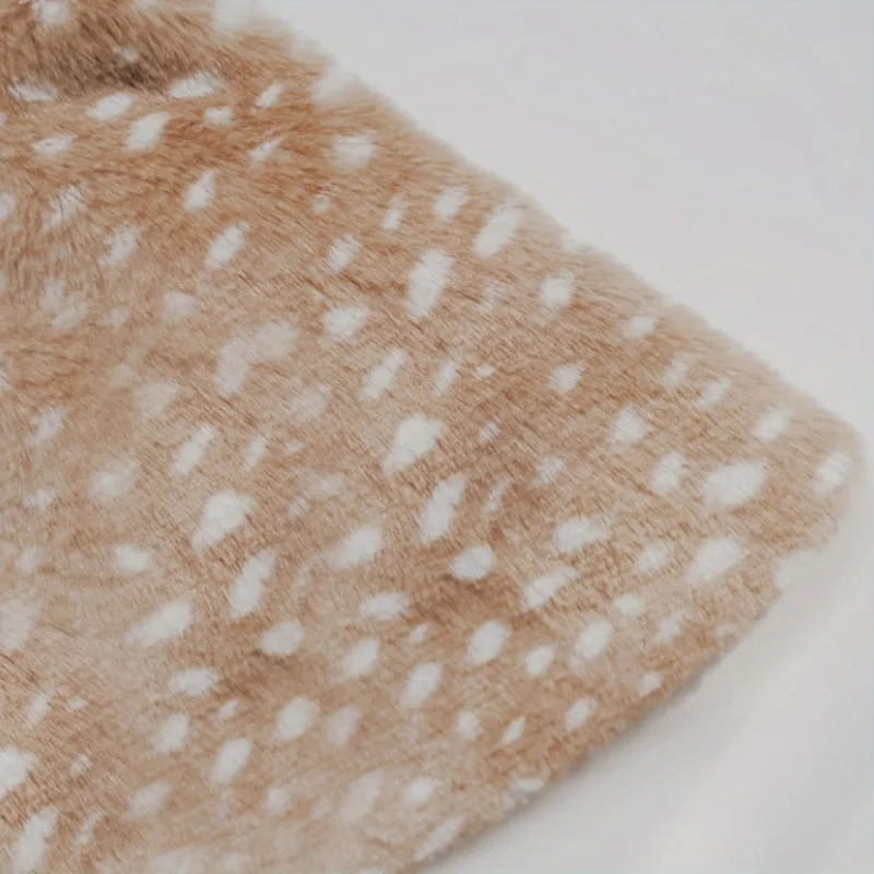 a soft beige faux fur blanket with white spots featured as part of pet dog clothes reindeer winter costume